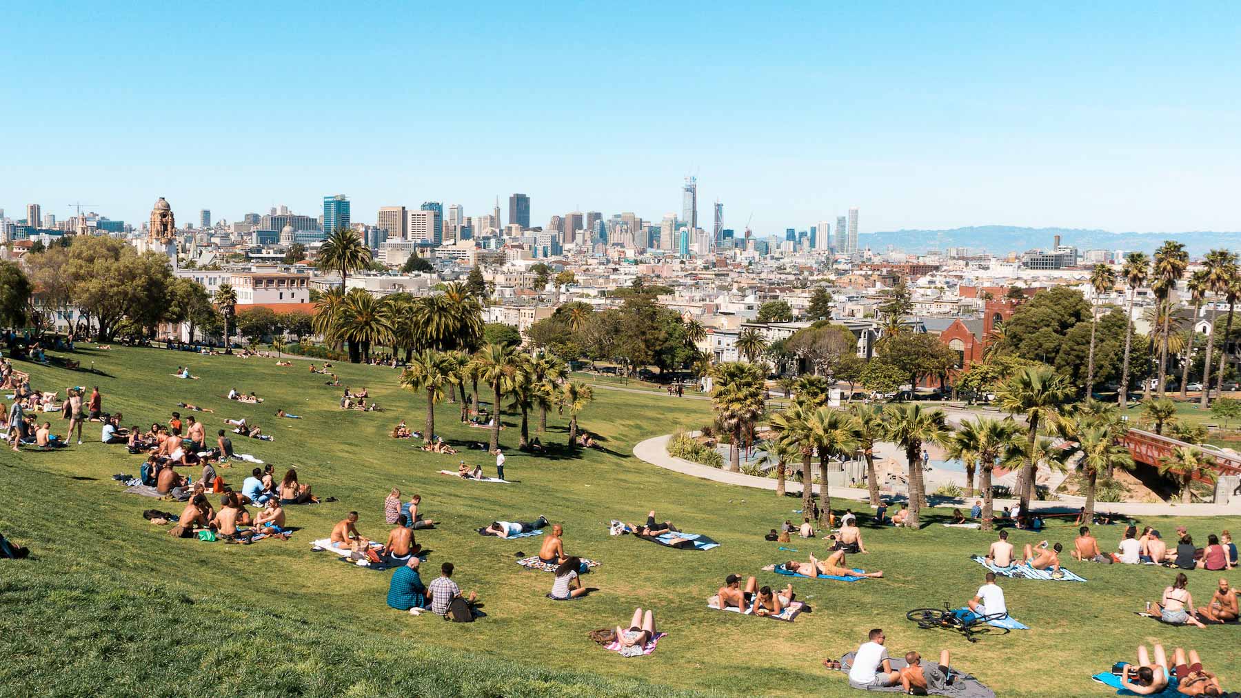 Locals basking in Mission Dolores Park in San Francisco's Mission neighborhood on a sunny day